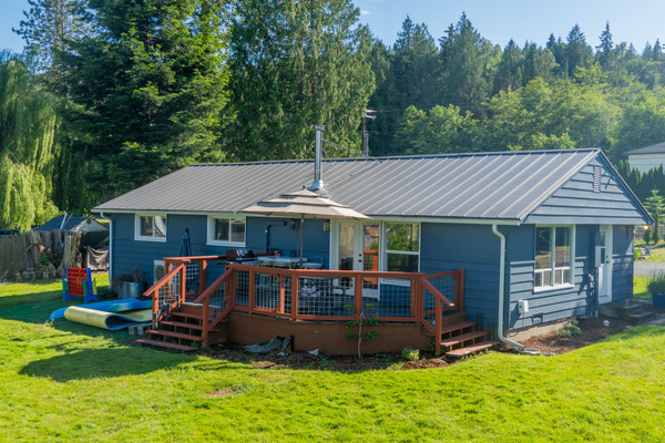 A single-level lakeside home with blue walls and red accents, blending charm and calm in a welcoming setting.