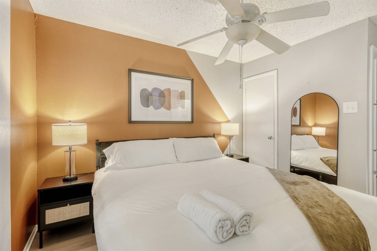 Warm and cozy bedroom with modern decor and soft lighting.