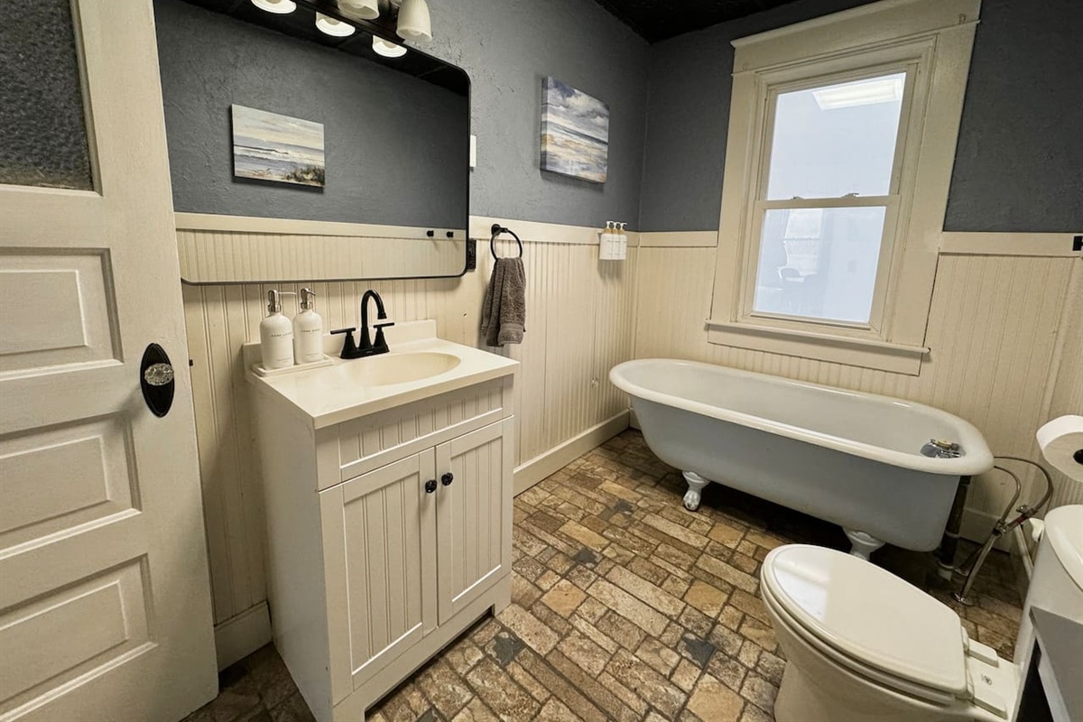 Main Level Bathroom - Relax in the vintage clawfoot tub. (Note: This bathroom features a tub only, no shower).