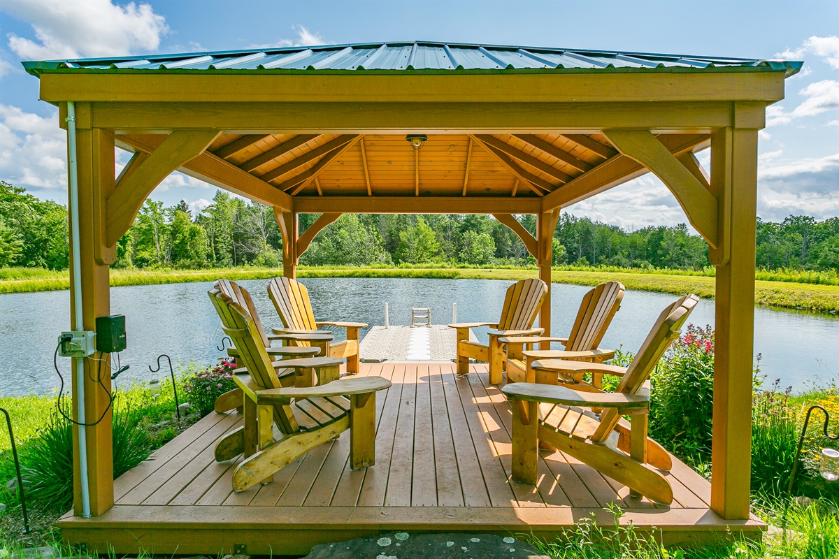 Gather with friends and family beneath a rustic pavilion by the pond, complete with classic Adirondack chairs and picture-perfect views.
