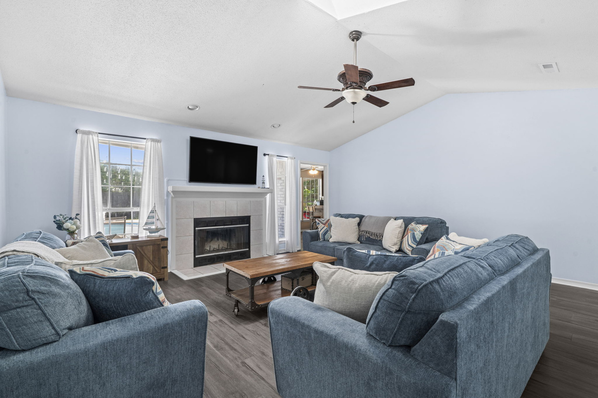 A bright, open living space with pool views through the window — ideal for lounging between swims.
