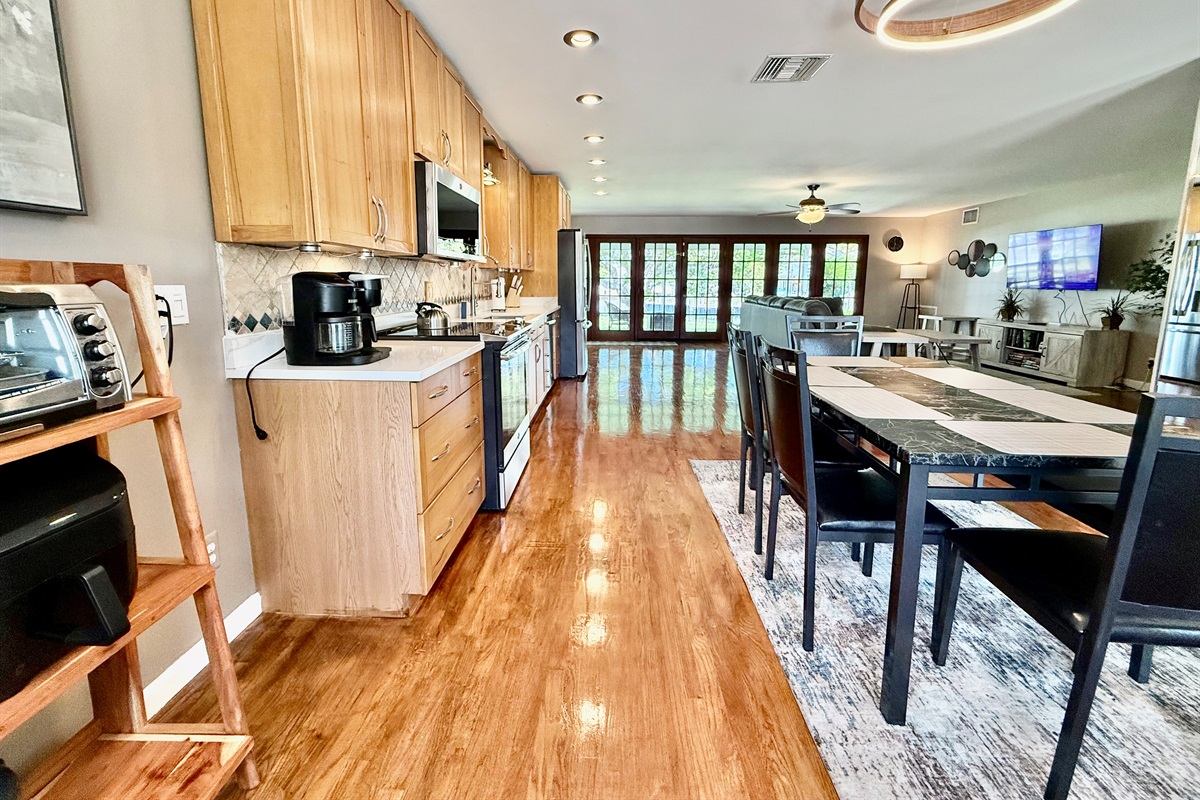 With warm wood tones, sleek countertops, and modern amenities like a Keurig and French-door fridge, this kitchen invites you to cook, gather, and make lasting memories.