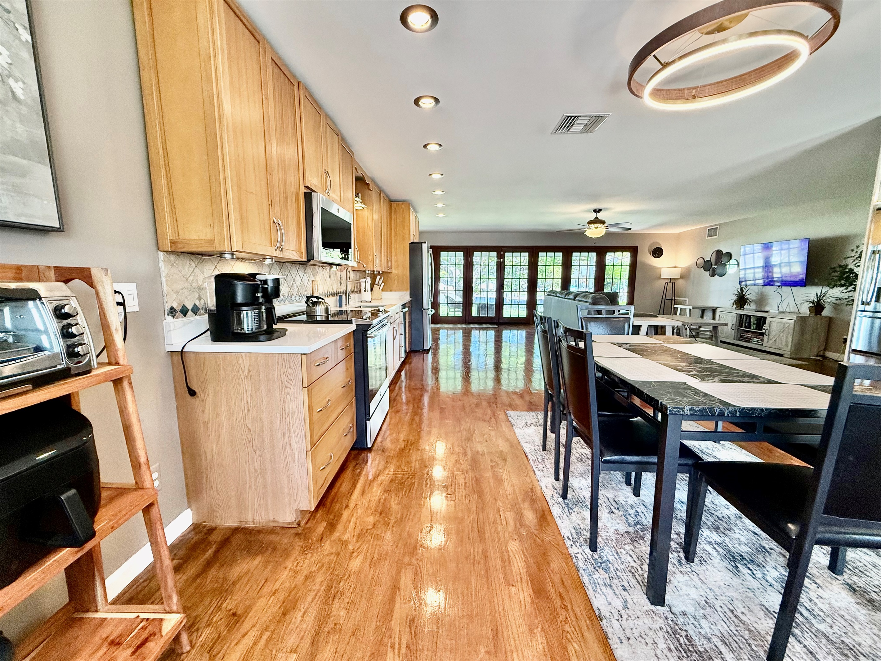 With warm wood tones, sleek countertops, and modern amenities like a Keurig and French-door fridge, this kitchen invites you to cook, gather, and make lasting memories.
