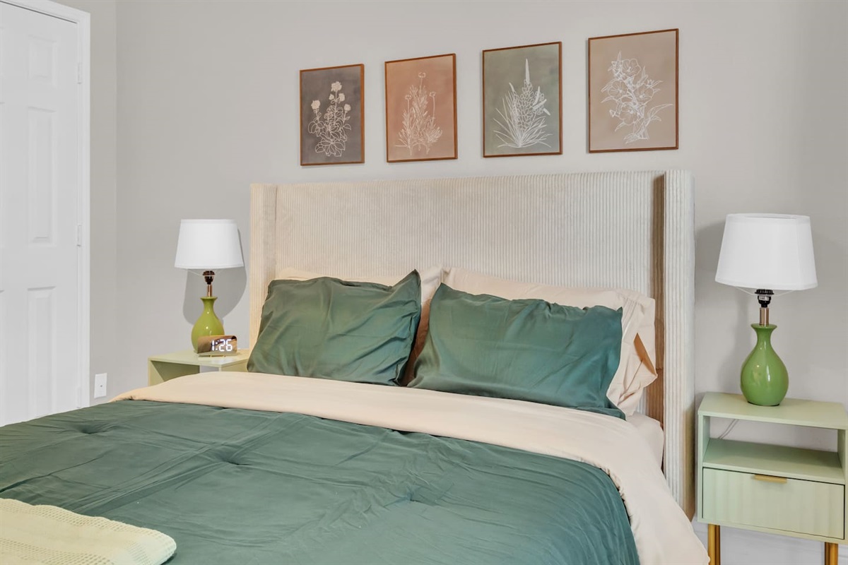 Well-appointed queen bedroom with blackout blinds, ceiling fan, modern décor, and a quiet atmosphere ideal for restful nights.