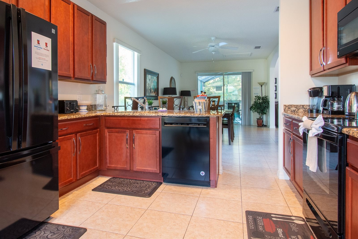 Fully stocked kitchen with granite countertops, stainless steel appliances, breakfast bar, and breakfast nook.