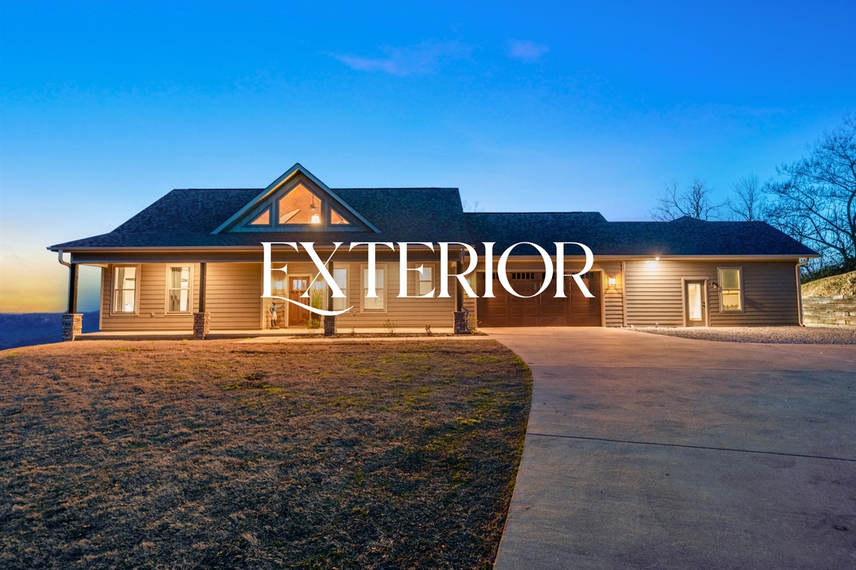 The front exterior welcomes you with charming curb appeal and a peaceful setting that hints at the views waiting behind the home.