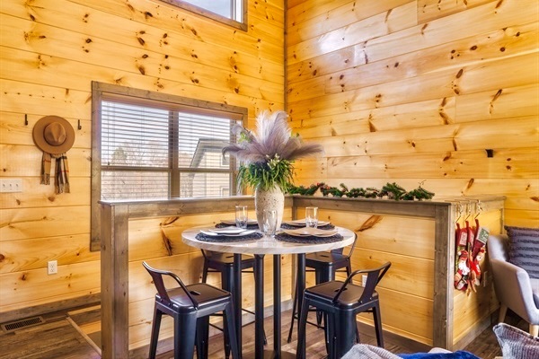 Cozy dining area with rustic charm, perfect for intimate meals or morning coffee, surrounded by warm wood tones and natural light.