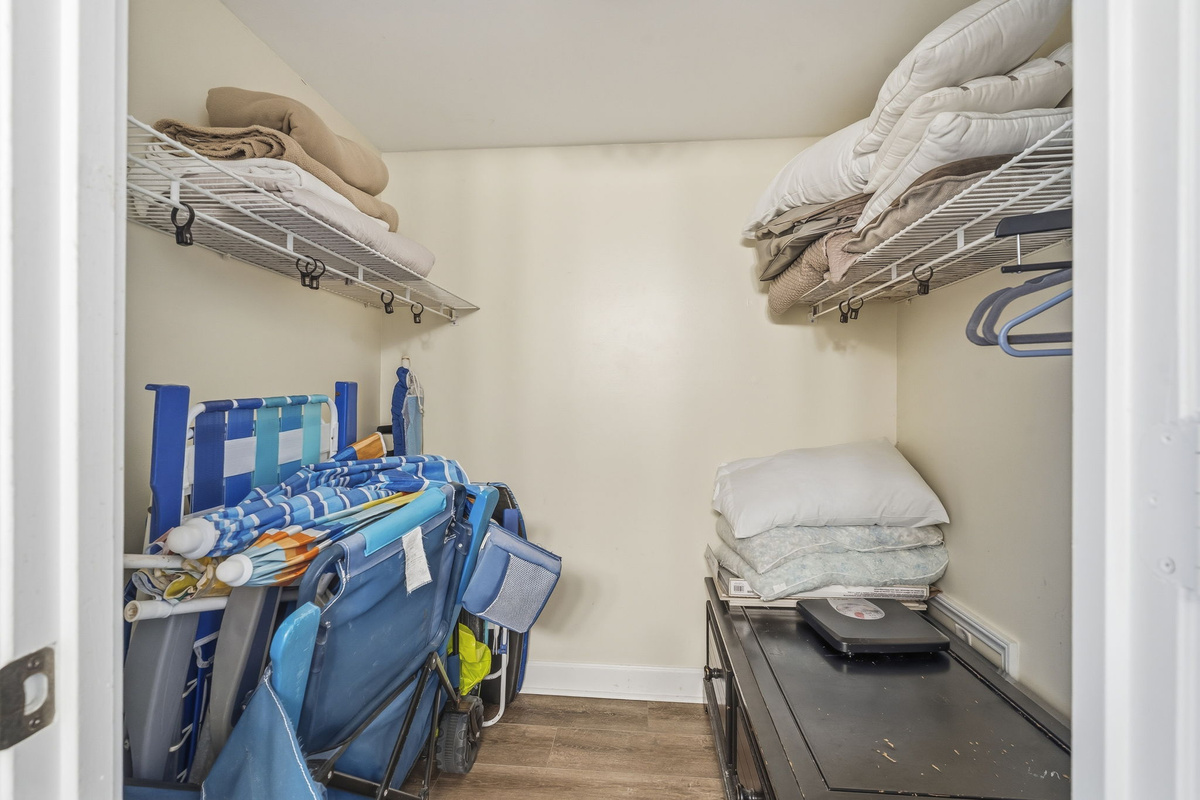 Closet with beach chairs, beach umbrella and extra linens