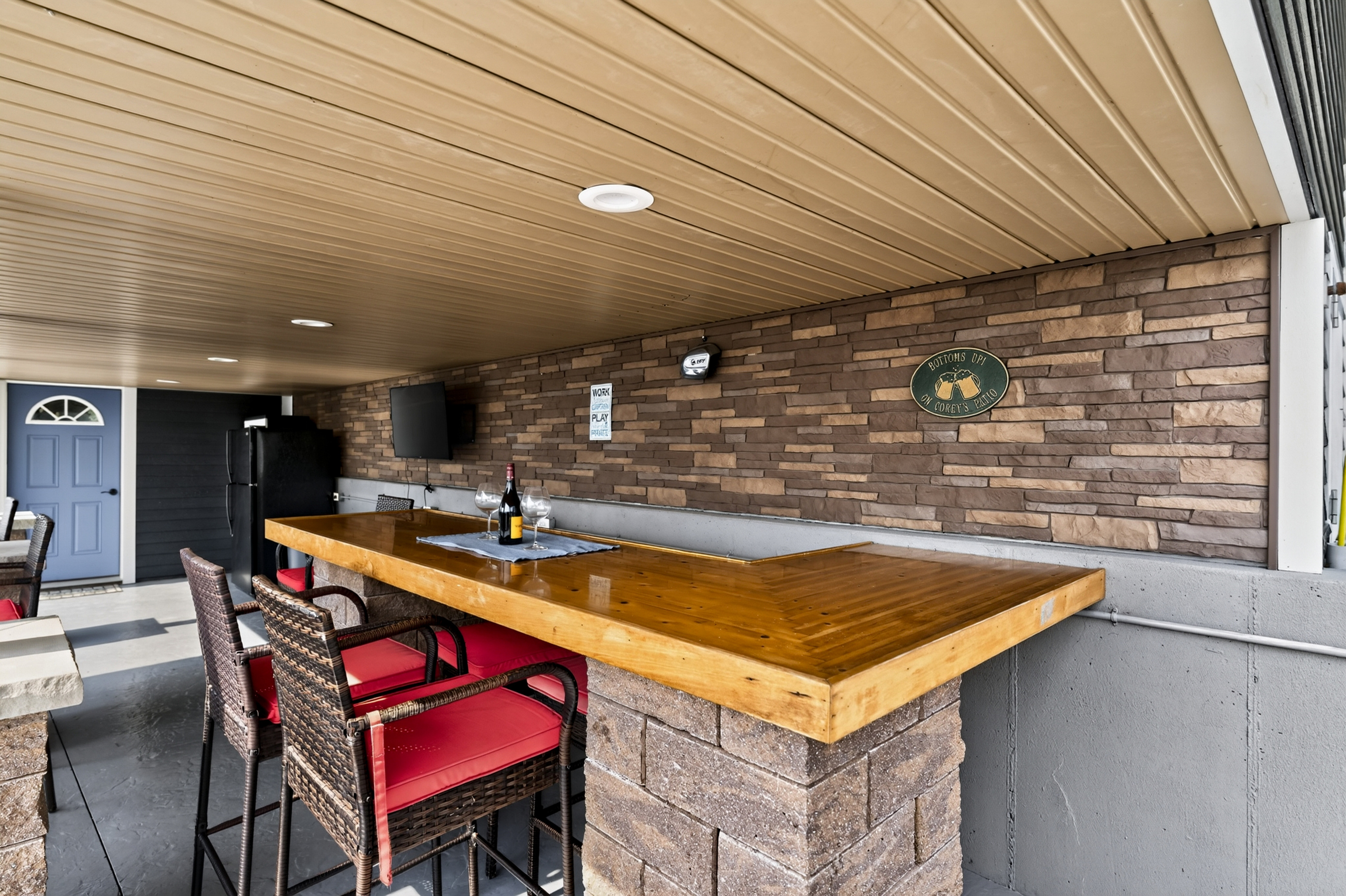 Covered outdoor bar with mounted television