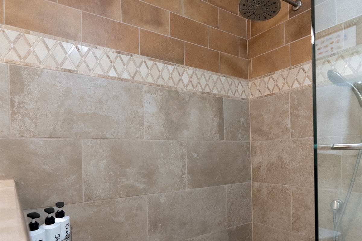 A beautifully tiled walk-in shower for a spa-like experience to start your day.