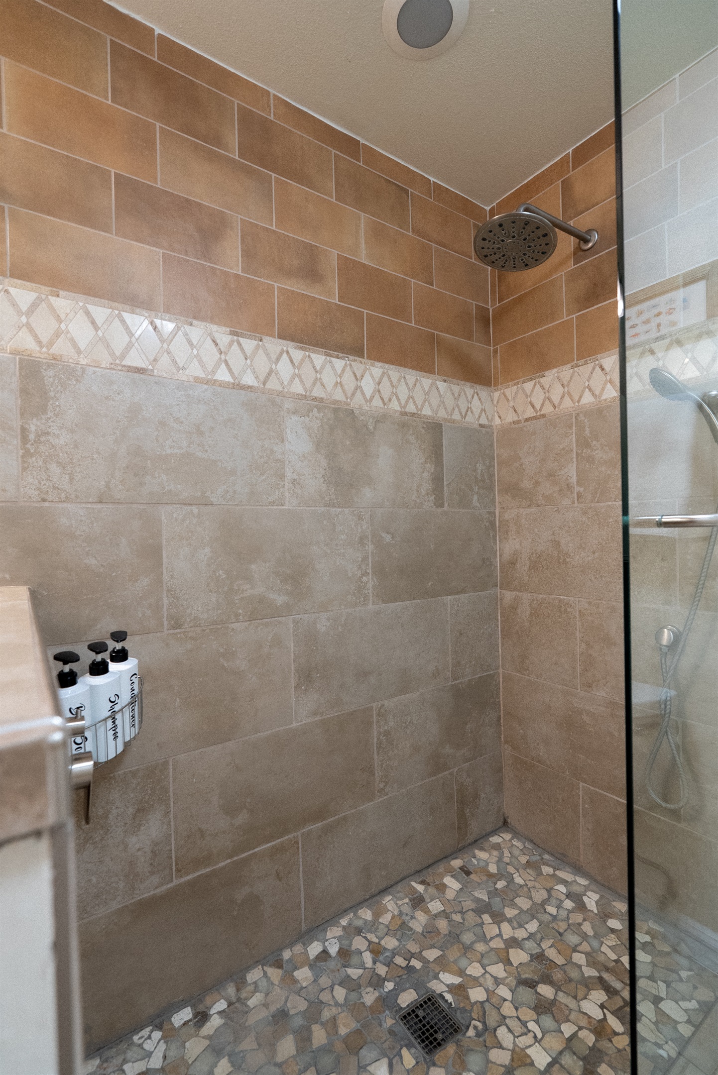A beautifully tiled walk-in shower for a spa-like experience to start your day.