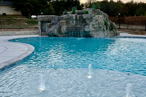 Resort style 30,000-gallon saltwater pool with double waterfalls and grotto and slide
