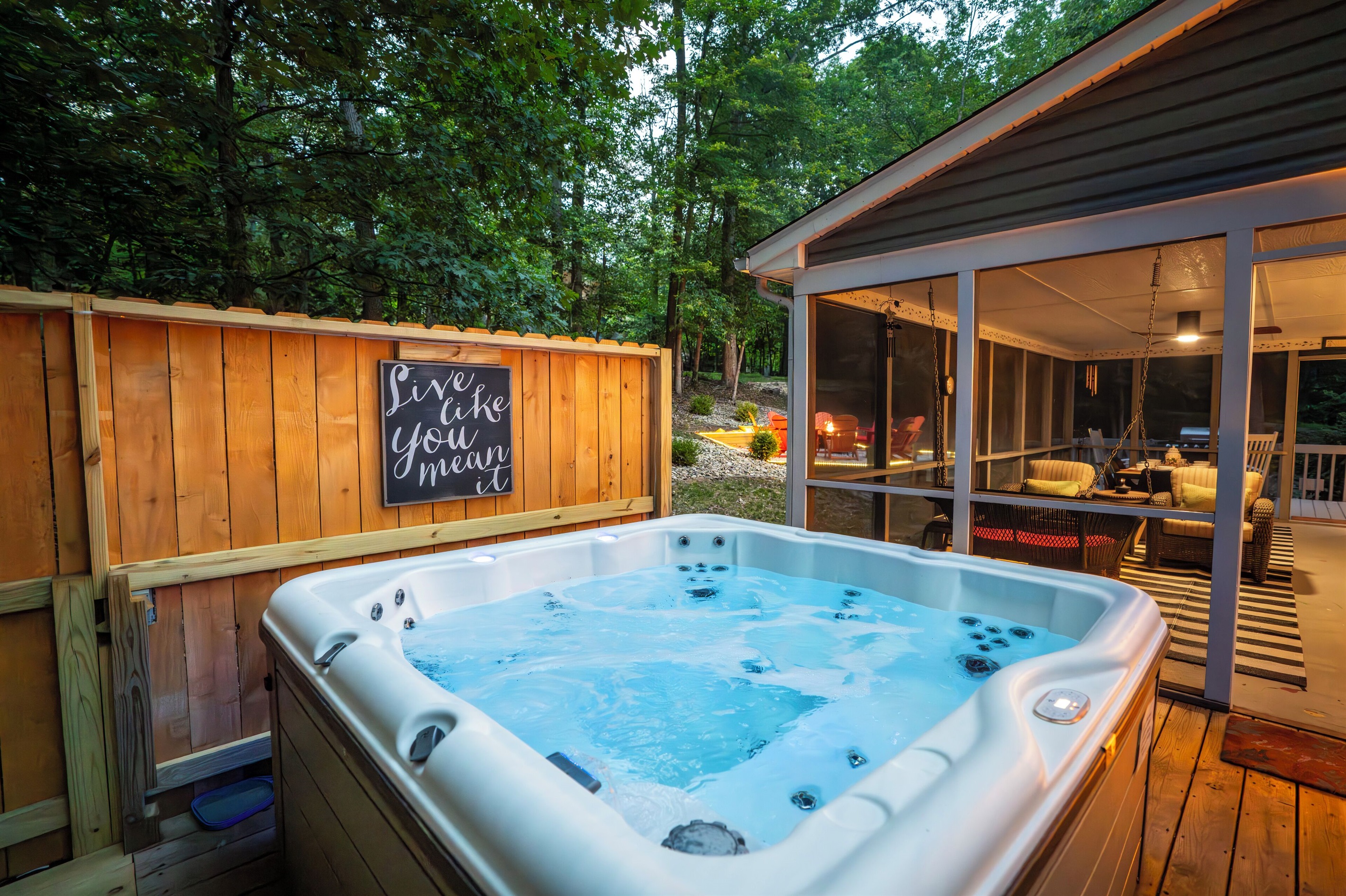 Deck with hot tub, sauna, and propane firetable / seating area
