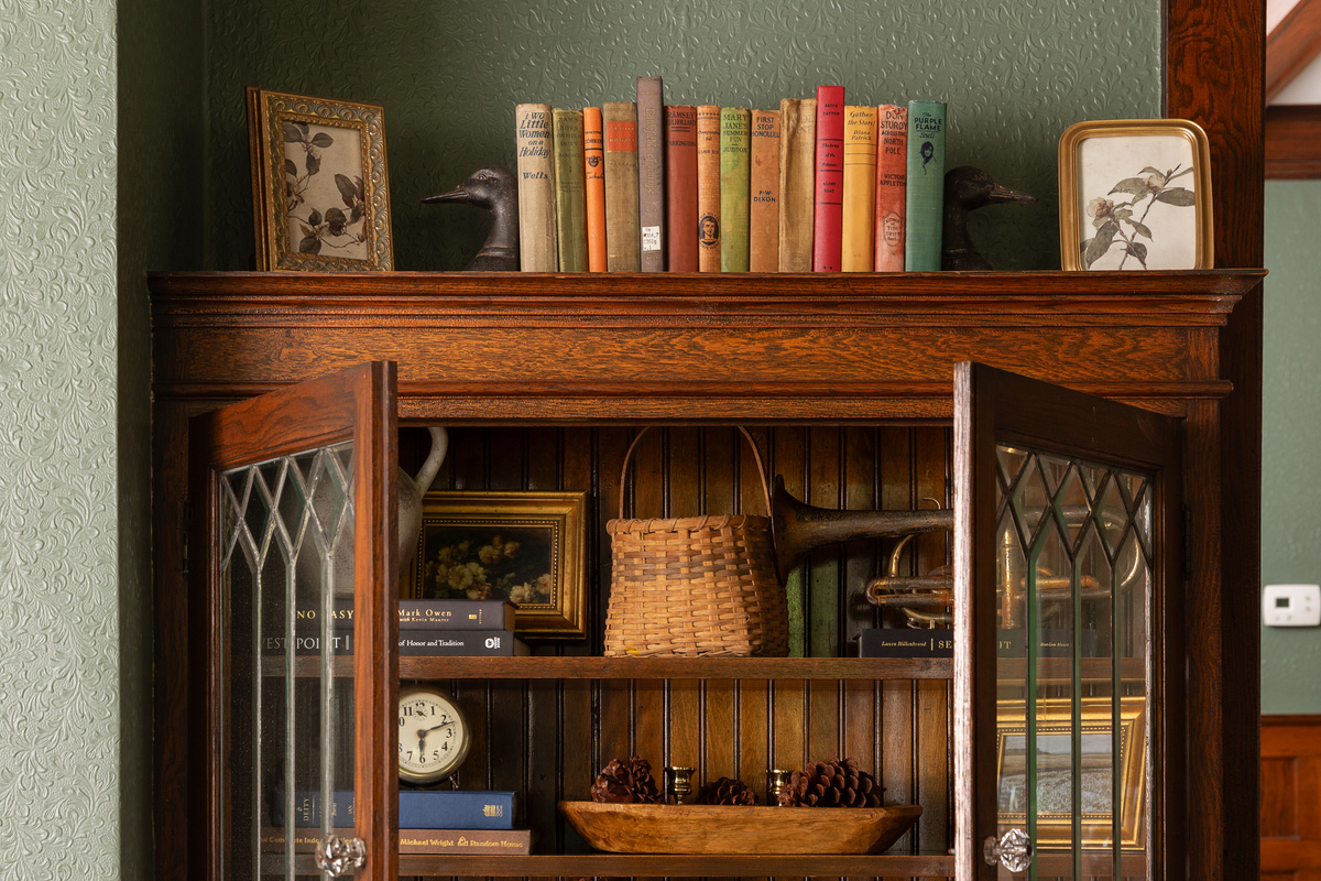 Original leaded glass built ins and warm woodwork add timeless charm throughout Friday Farm. Thoughtfully styled spaces blend historic character with modern comfort for a stay that feels both elegant and inviting.