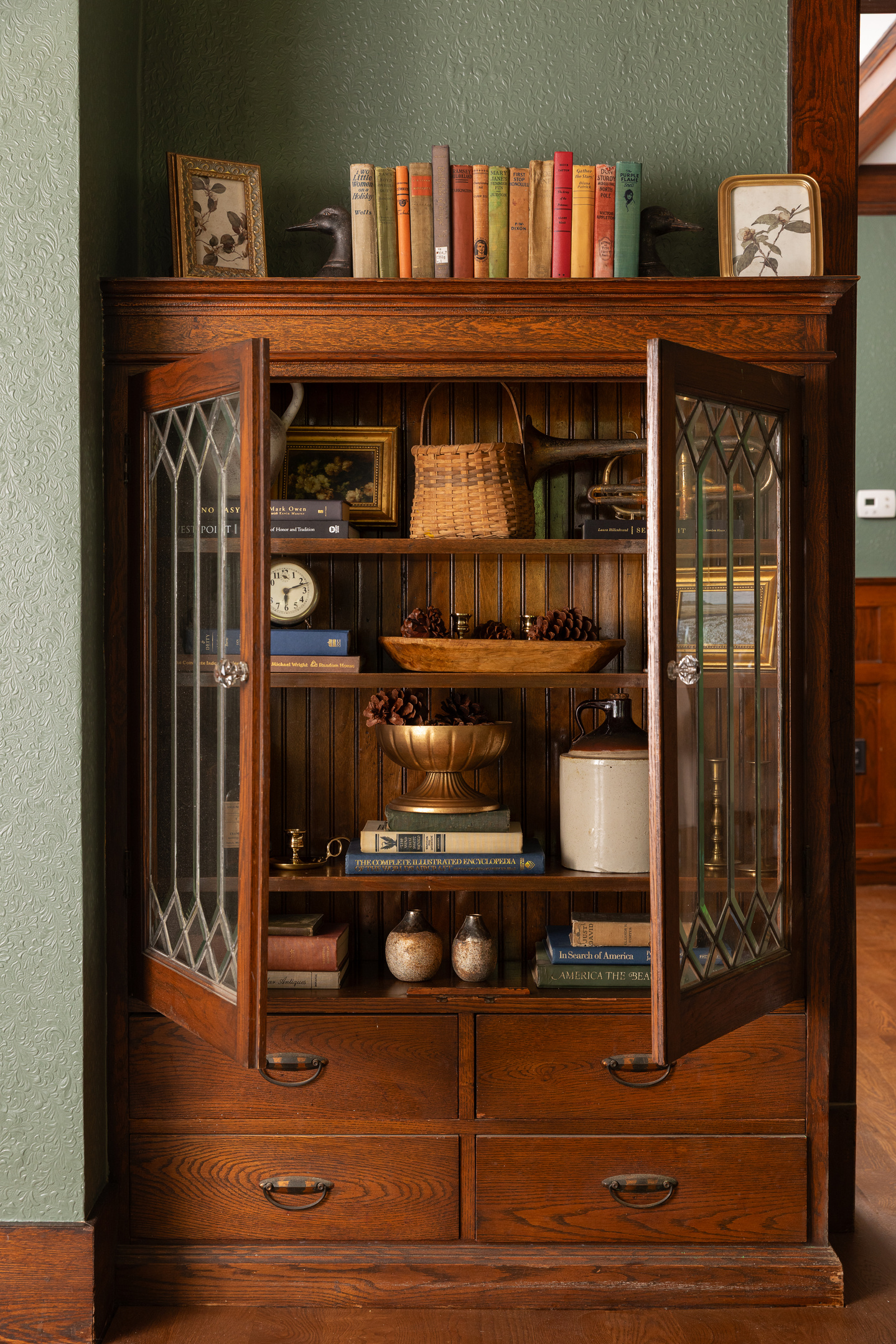 Original leaded glass built ins and warm woodwork add timeless charm throughout Friday Farm. Thoughtfully styled spaces blend historic character with modern comfort for a stay that feels both elegant and inviting.