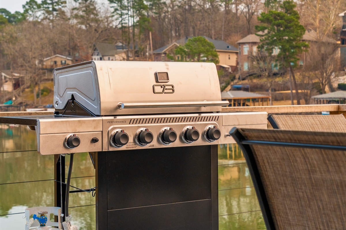 The outdoor grill makes it easy to cook up lakeside meals while enjoying fresh air and scenic views.