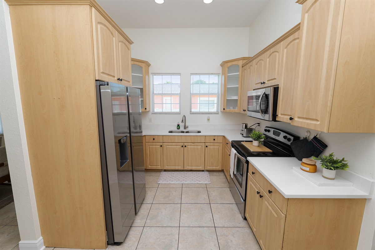 Airy and modern with subtle farmhouse flair—this kitchen’s warm tones and natural light make it a joy to cook in.