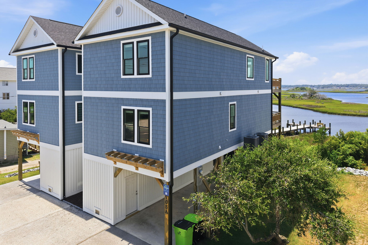Aerial view showcasing the home's beautiful coastal design, spacious layout, and picturesque marshfront setting