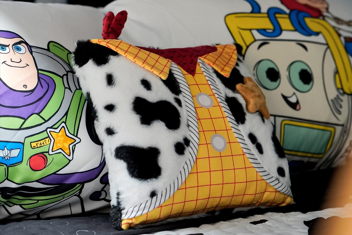 Toy Story Adventure Detail: Playful Woody decorative pillow adds another themed touch to this immersive Toy Story bedroom.