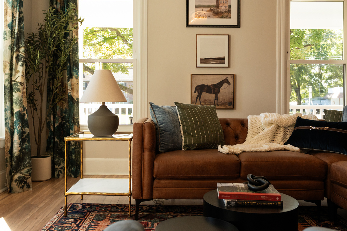Settle into the cozy living room, where warm textures, original character, and thoughtfully collected details make Hudson Heritage House feel like home.
