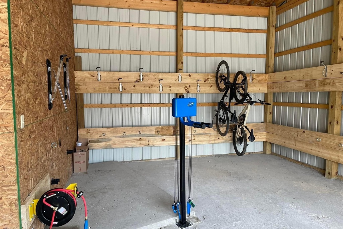 Bike Storage with air compressor, work station and e-bike charging.
