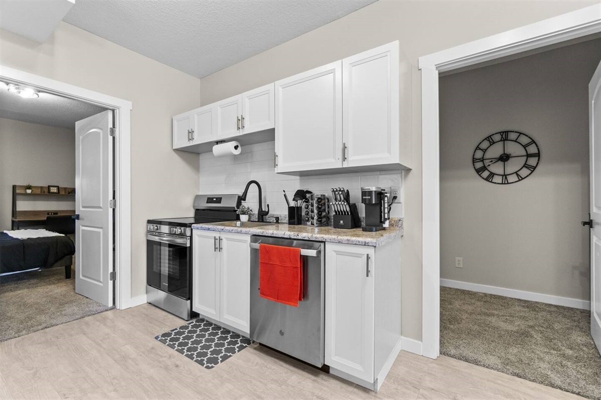 Fully stocked kitchen featuring brand-new cabinets, sleek countertops, and modern appliances for all your cooking needs.