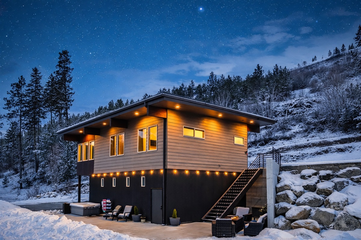 Winter vibes at Starfall Guesthouse - back of the unit with the outdoor amenities: lounging with fire table and gas BBQ, both with propane provided, additional seating and hot tub for 4 people