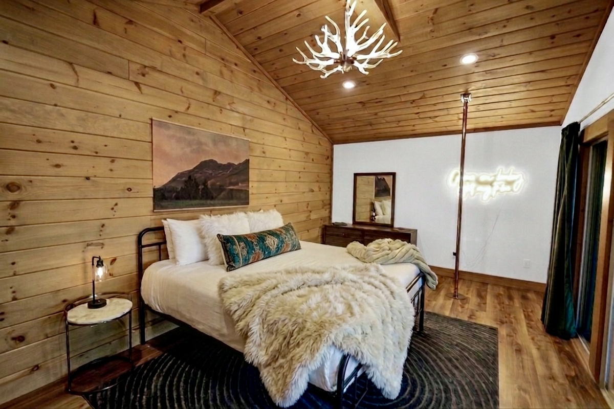 Sparks fly at The Flame Cabin! A wall of glass frames panoramic mountain views from bed.  Cozy up by the fire as the sun sets or enjoy our fun dancing pole... so much to do you'll never want to leave!