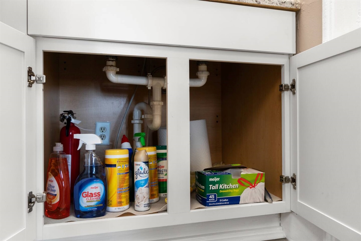 Cleaning materials are conveniently stored in the sink cabinet for easy access during your stay.