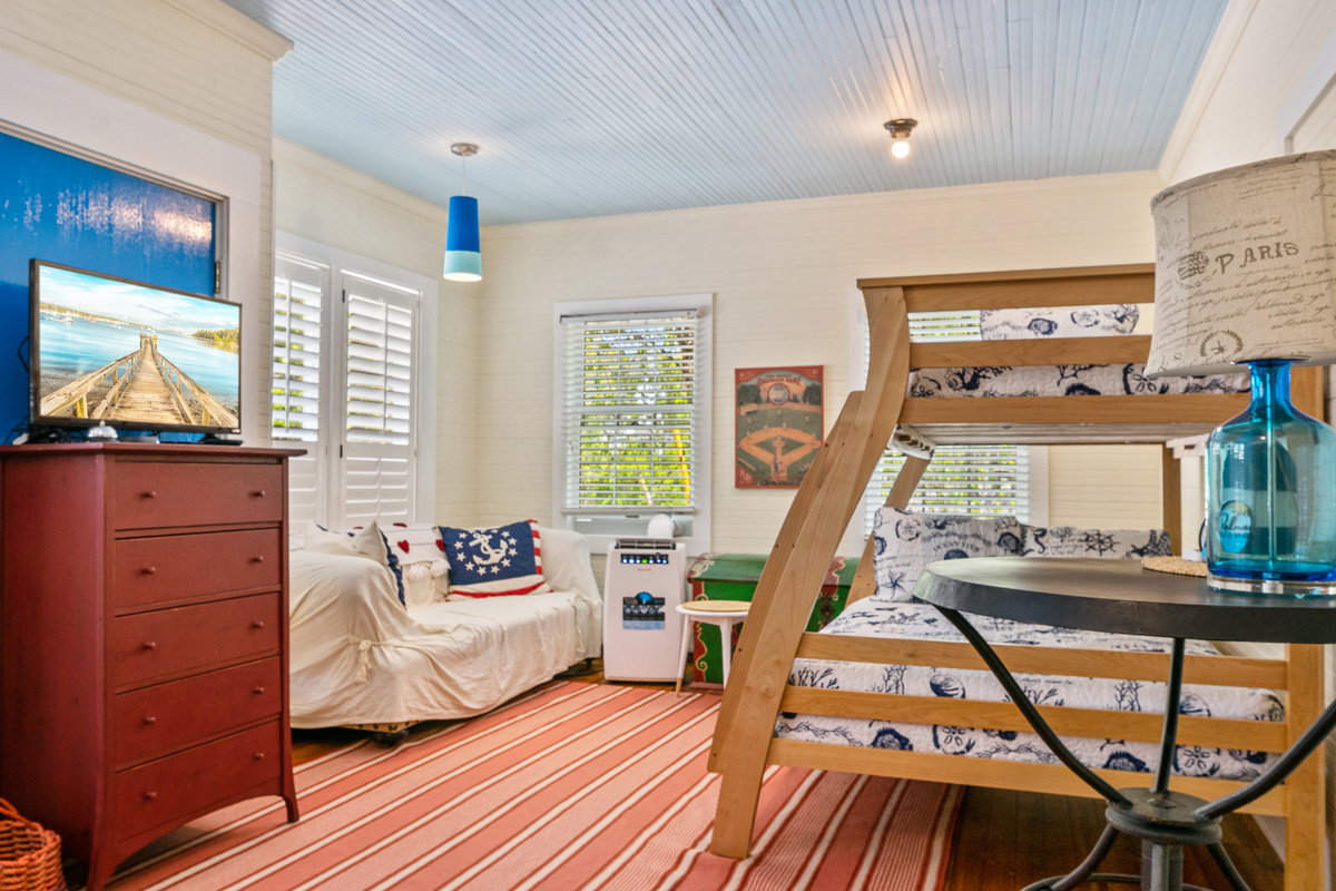 The "Crew’s Quarters" bunk room is a dedicated world for younger sailors. Outfitted with custom ship-themed linens on the twin-over-full bunk, its own cool AC, and a private Roku TV setup for wind-down entertainment.