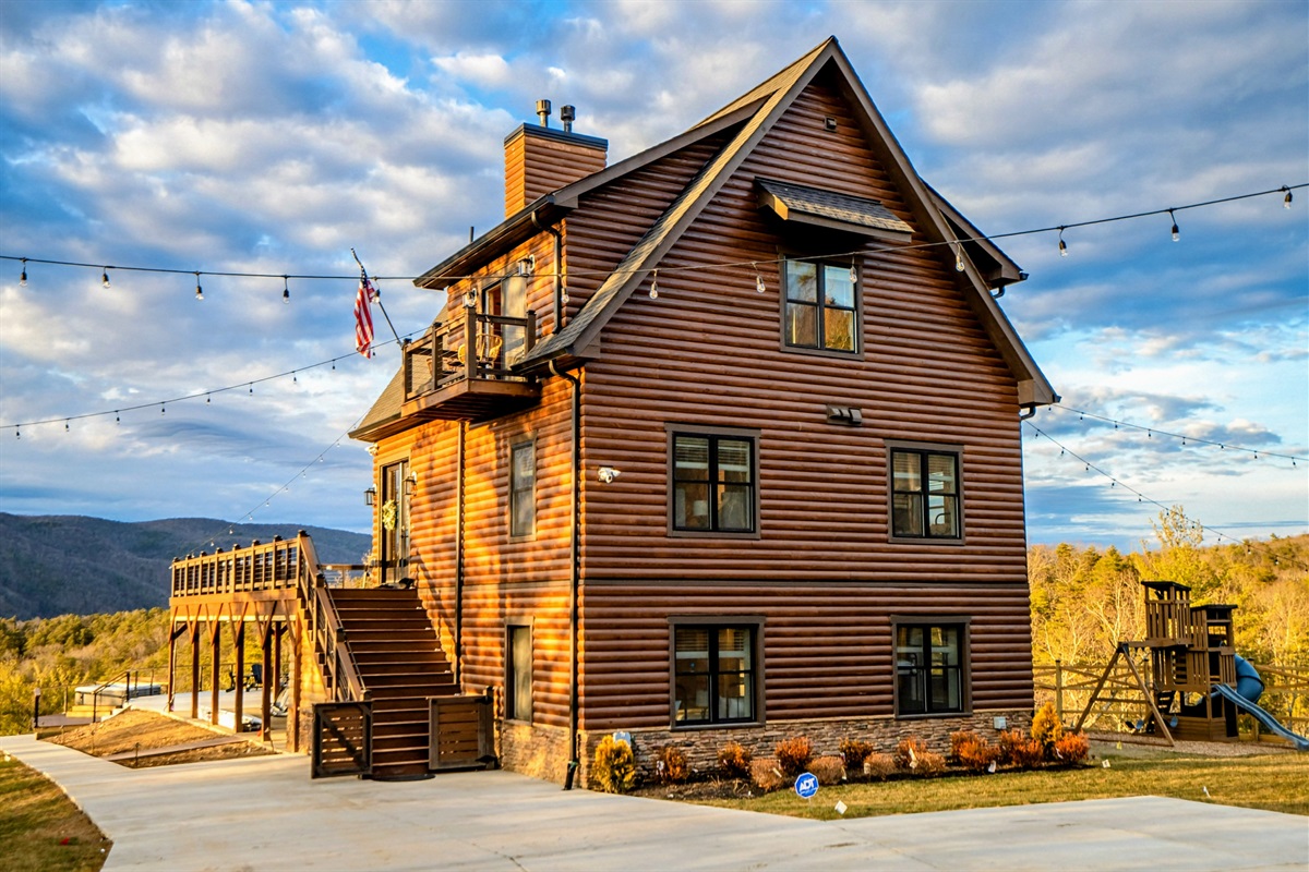 Where Gatherings Begin – A wide driveway, warm lodge lighting, and endless views set the stage for special moments with family and friends.