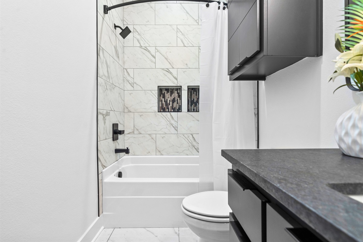 A contemporary bathroom designed with clean lines, bright lighting, and functional elements that elevate both style and comfort.