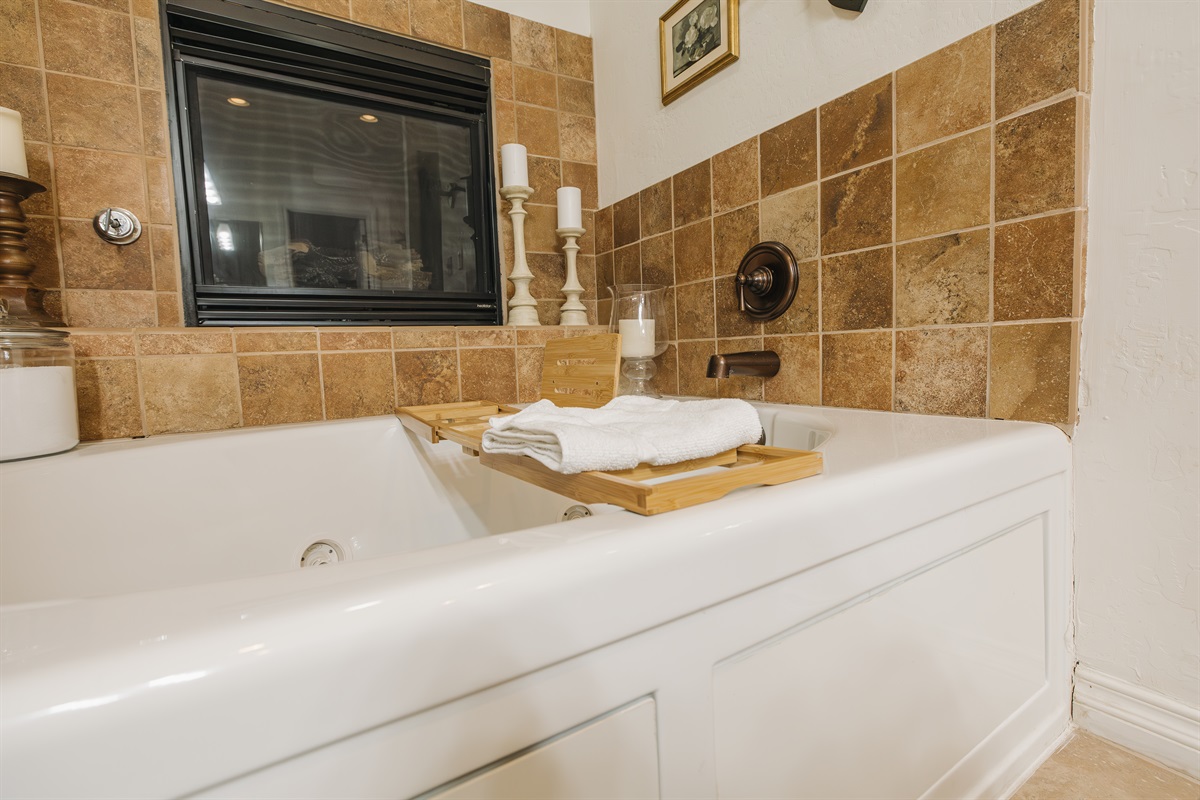 Soaking tub with jetted jets and cozy fireplace—unwind with a candlelit bath after a day of mountain adventures. A spa-like retreat designed for pure relaxation.