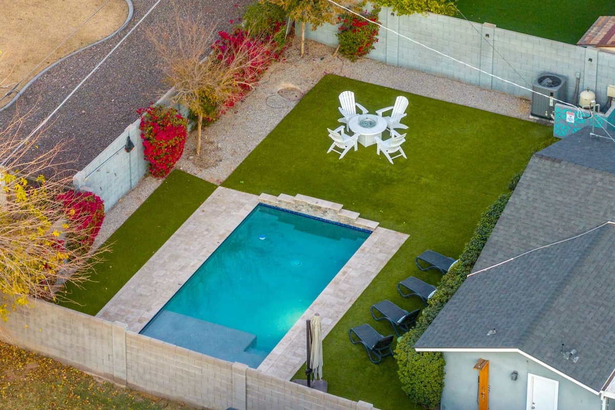 Aerial view highlighting the beauty of our poolside, with its sparkling water, comfortable seating, and surrounding greenery, creating a peaceful retreat.