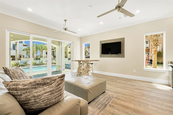 1st floor family room w/ teak bar and direct access to the private pool