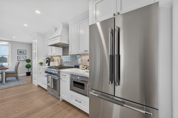 Bright, open kitchen with stainless steel appliances and abundant storage
