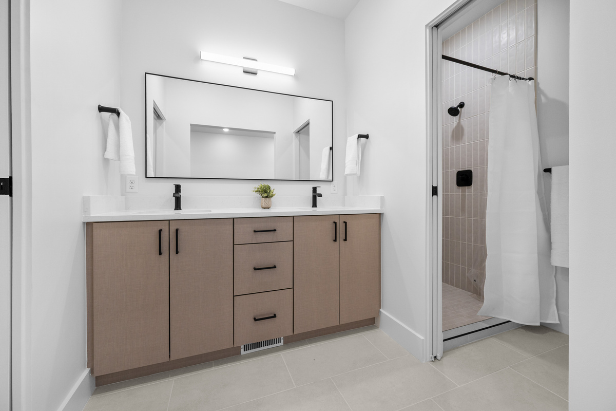 Spacious upstairs bathroom with double vanity and walk-in shower.