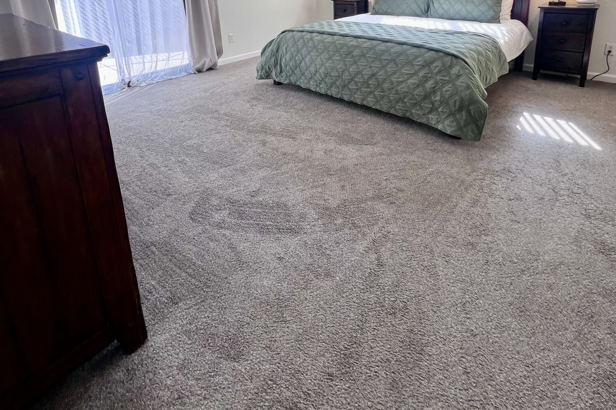 Escape to the master suite with a king-size bed and sliding door to the backyard.