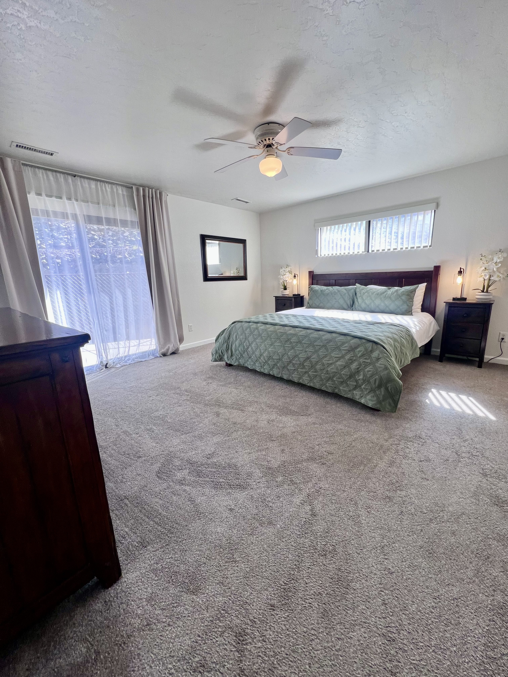 Escape to the master suite with a king-size bed and sliding door to the backyard.