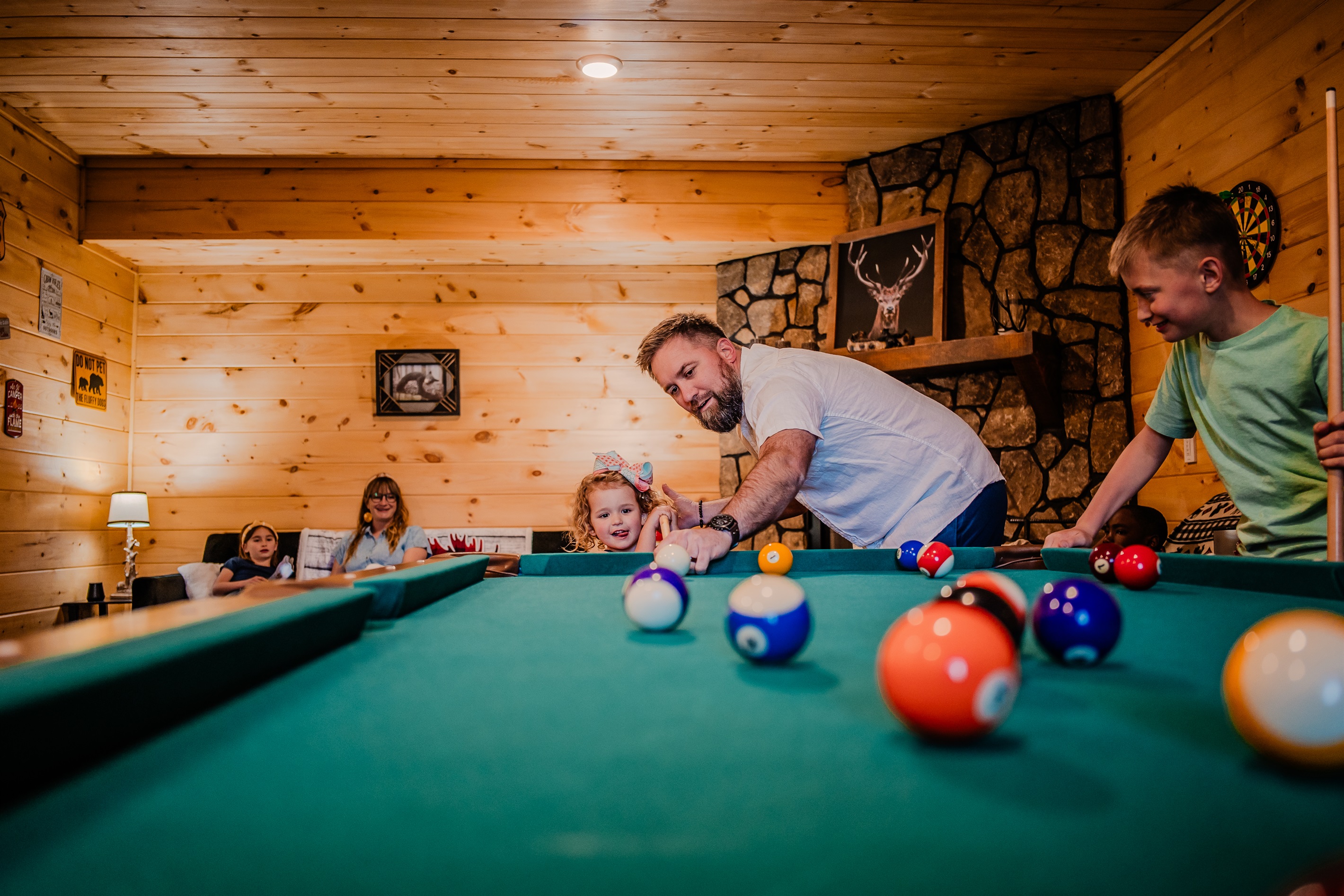 Basement game room includes a pool table for adults and kids to enjoy.