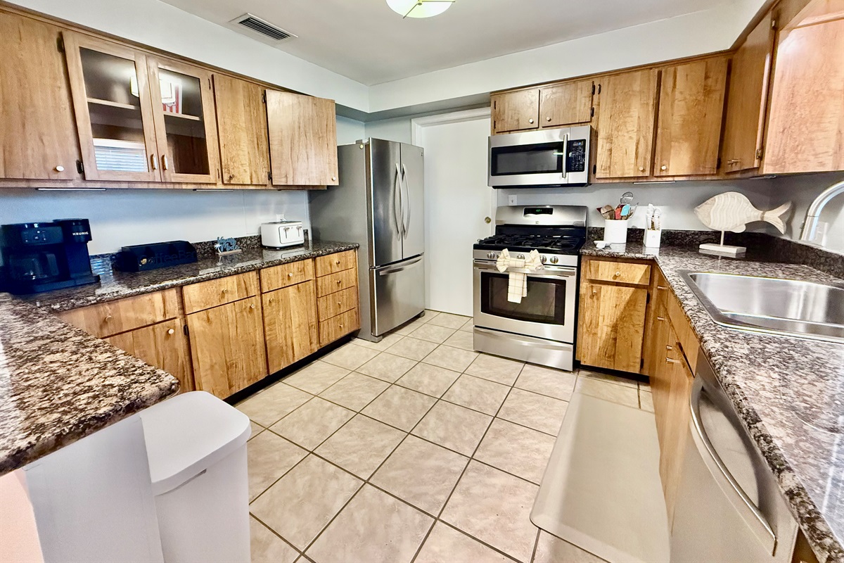 Warm wood cabinetry meets modern convenience in this stylish and functional kitchen.