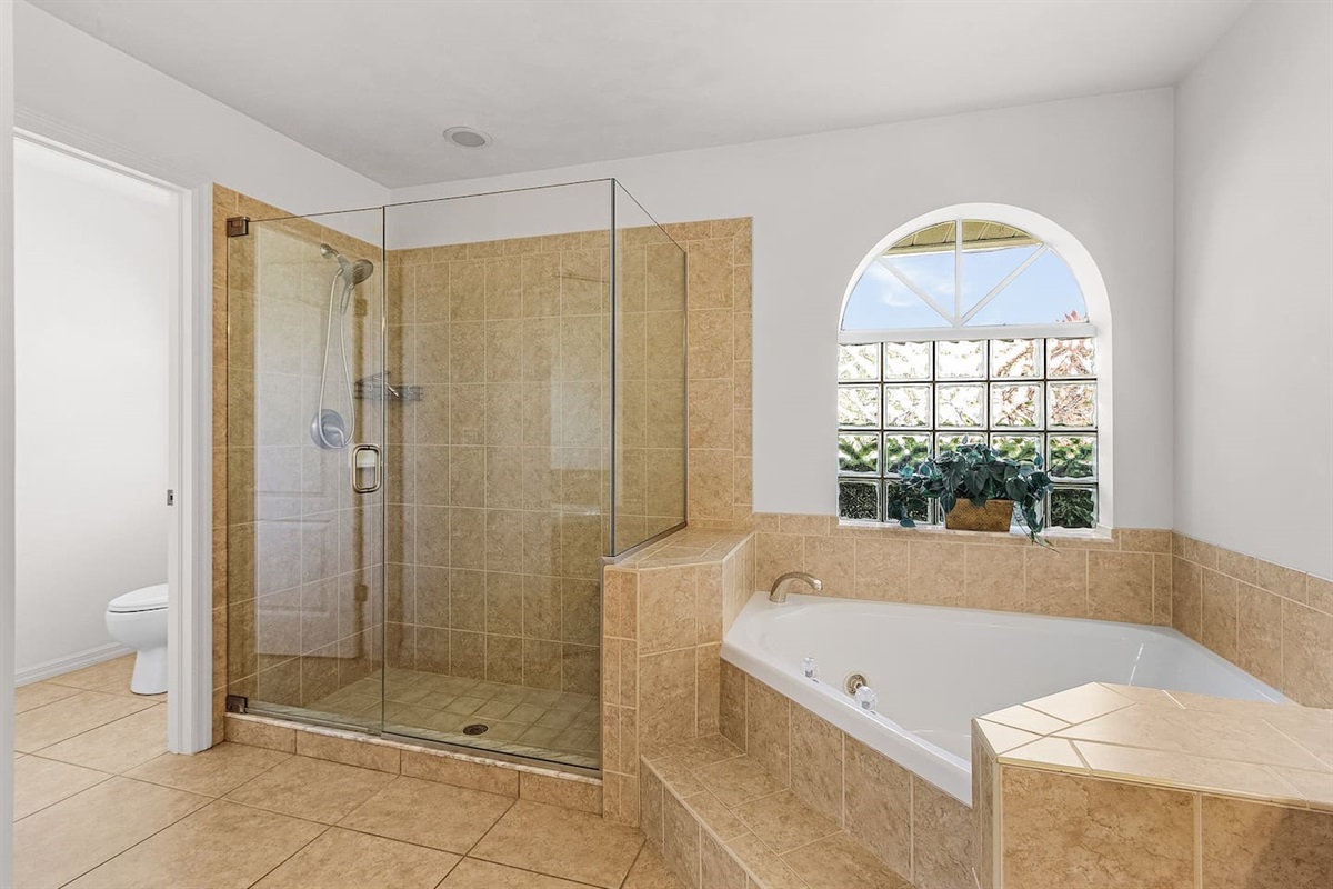 Your private spa retreat: primary bathroom with a large shower and separate soaking tub!