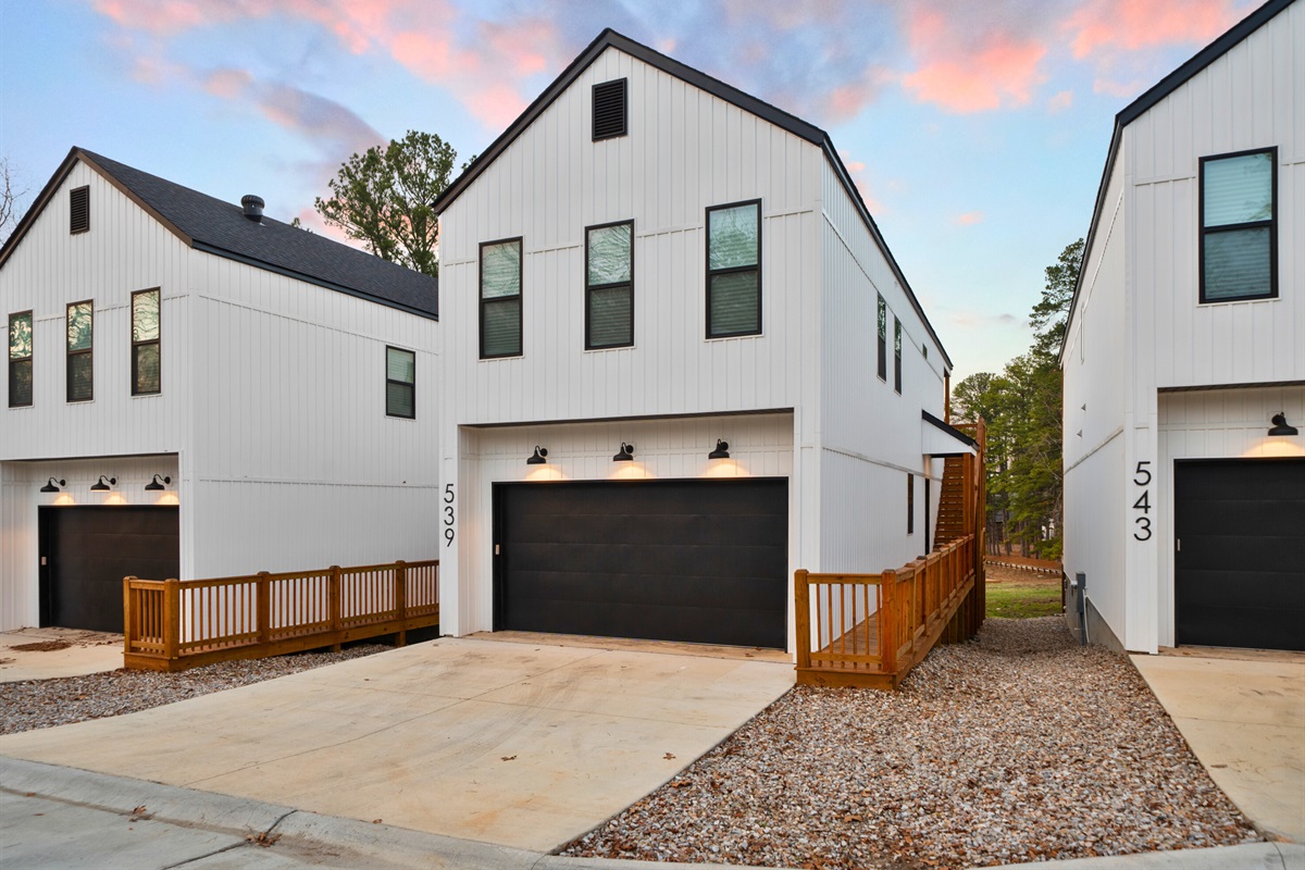 A clean, modern exterior with easy driveway access and a quiet lakeside setting.