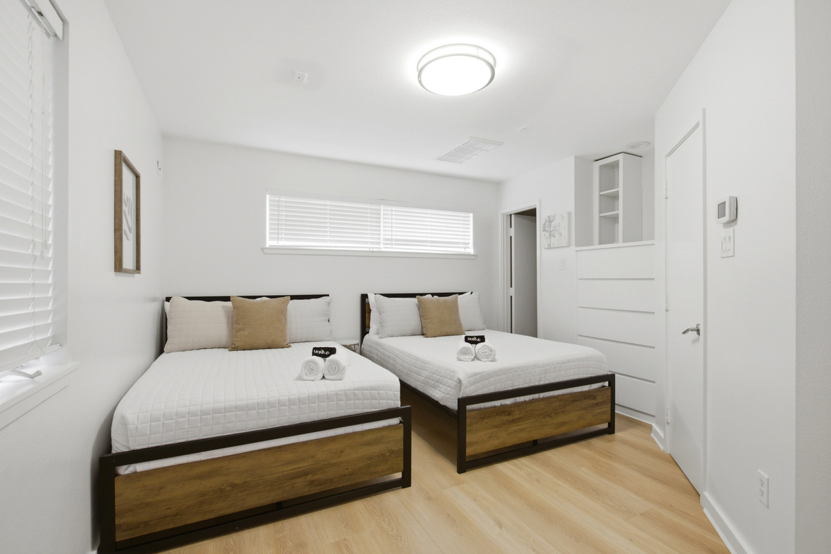 First-floor bedroom with two Full beds, sleeping up to 4 guests. Ideal for families, friend groups, or any arrangement that needs flexible sleeping on a separate floor from the rest.