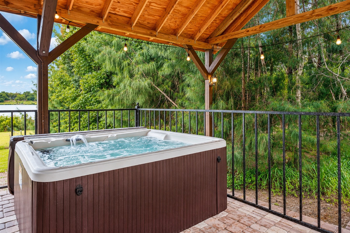 Private covered hot tub with peaceful lake views.