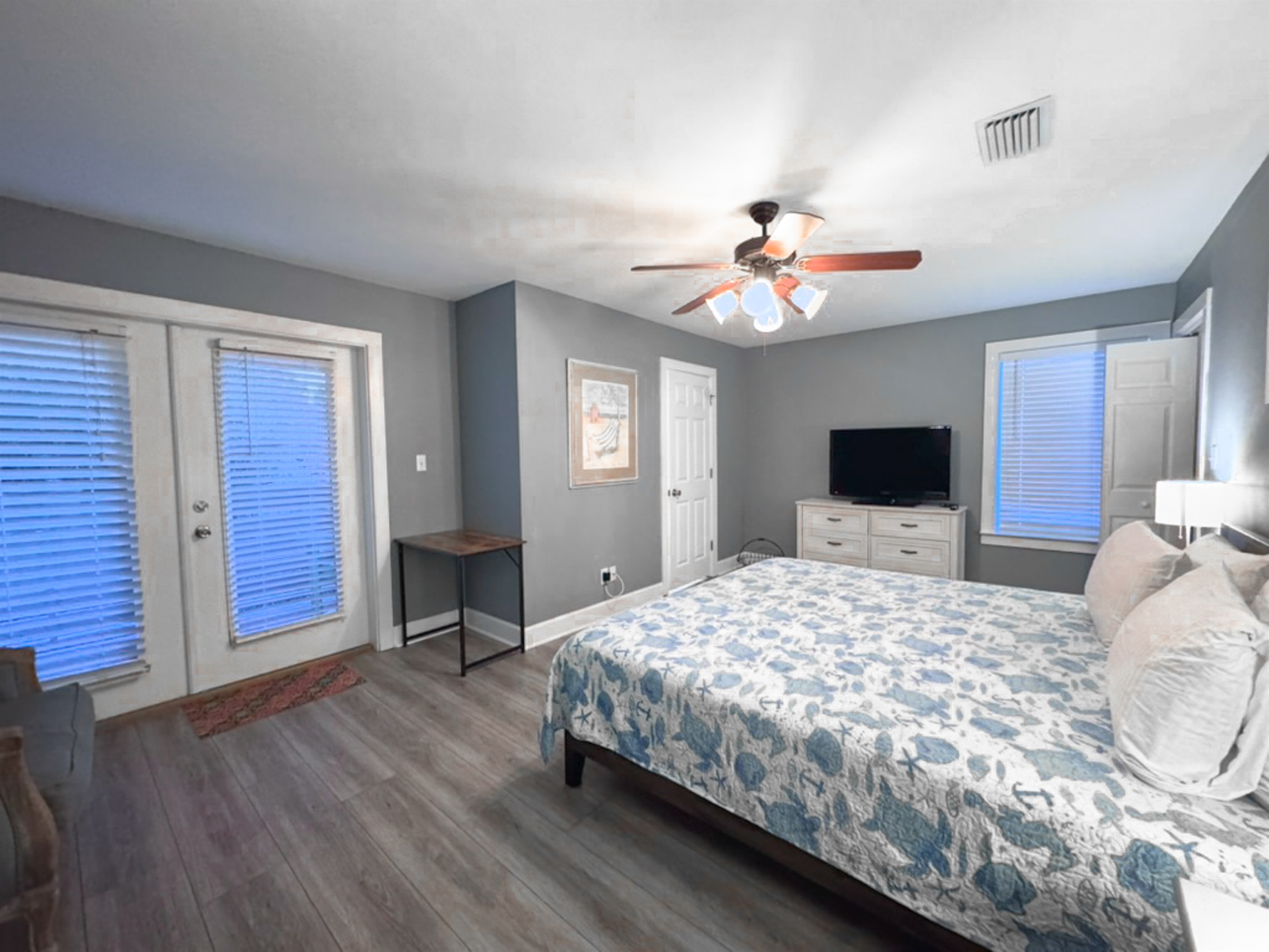 The master suite (Bedroom 6 of 6) with attached bath is spacious and includes a desk/chair for times you need to get work done. Those French doors lead to the balcony, with seating there.