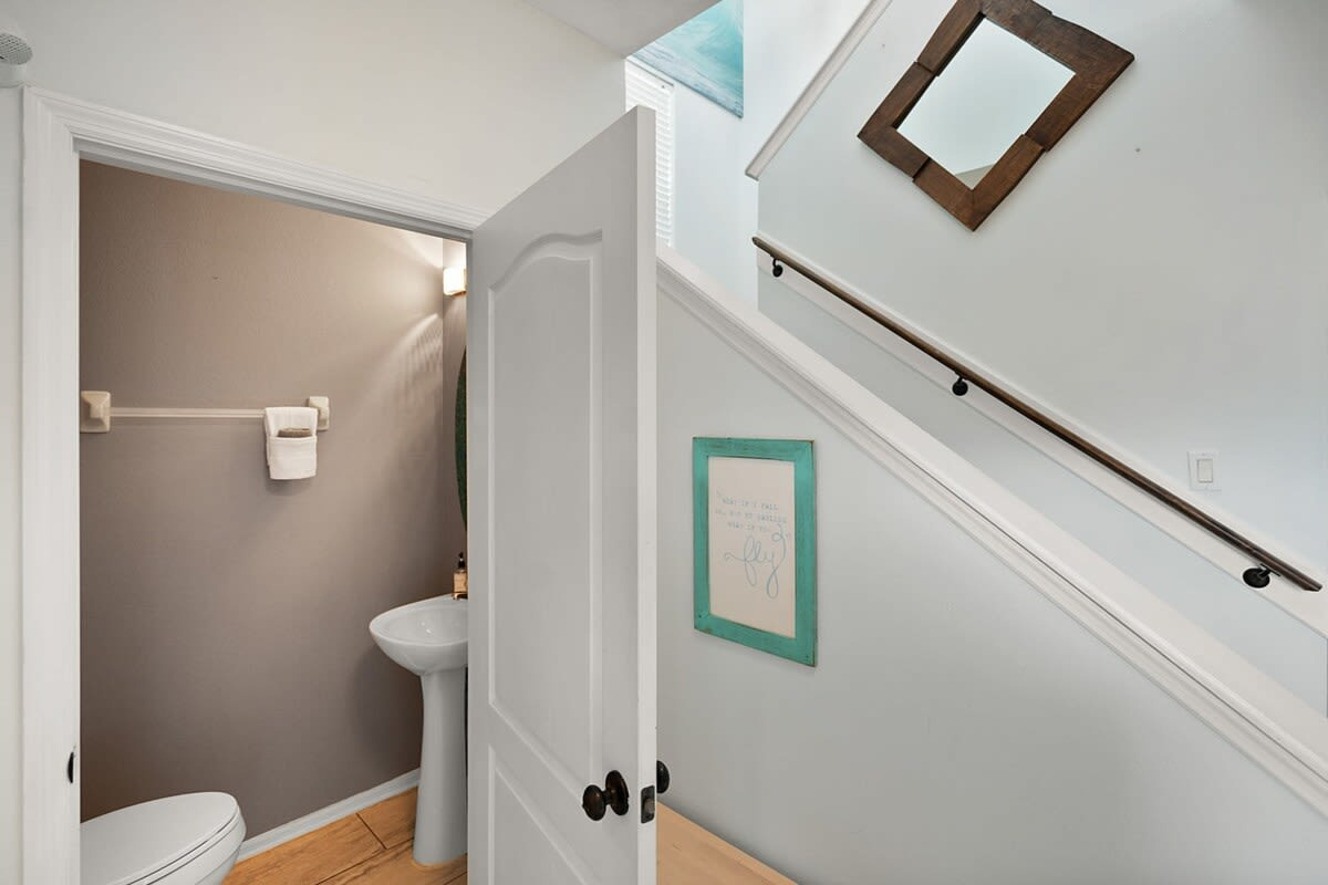 The half bath tucked under the stairs on the first floor, right beside the entry. A small thing, but with ten people in one house it turns out to be among the most quietly appreciated rooms in the place.