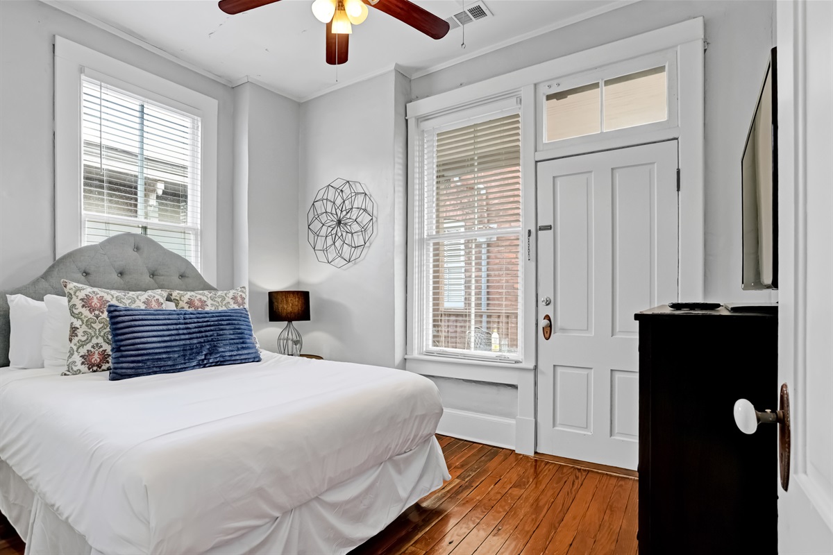 Bright and airy queen bedroom with plenty of natural light.