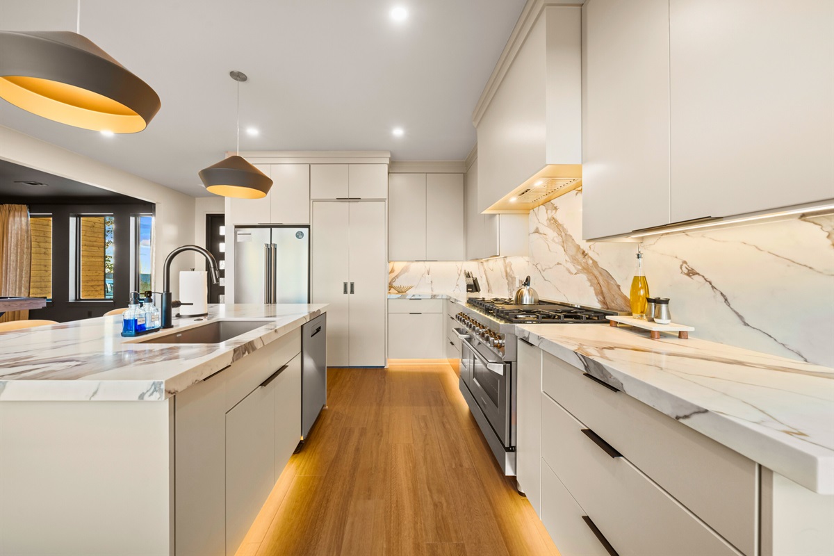 A sleek view of the kitchen that shows off the spacious counters and bright finishes, giving you all the room you need for snacks, meals, and everything in between.
