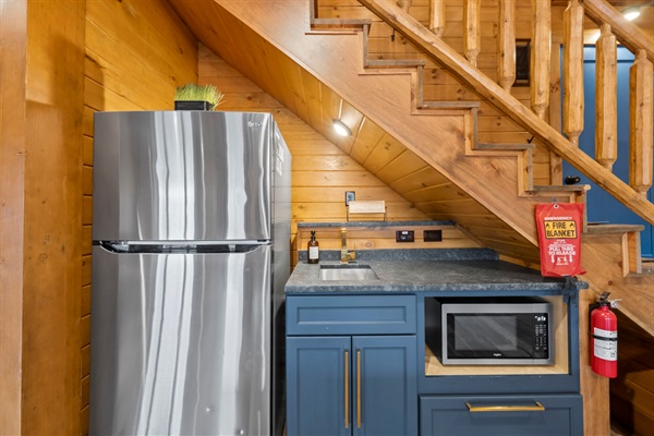 Game Room Kitchenette with Refrigerator and Microwave for Snacks and Drinks.